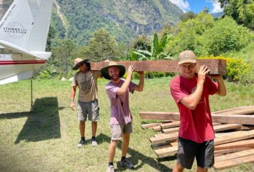 Men carrying building supplies