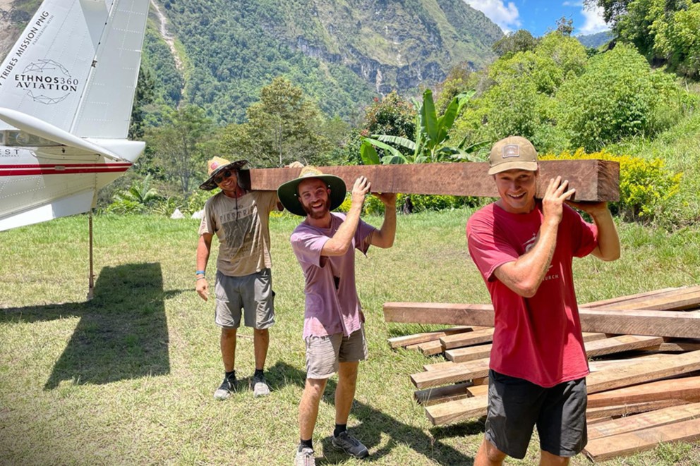 Men carrying building supplies